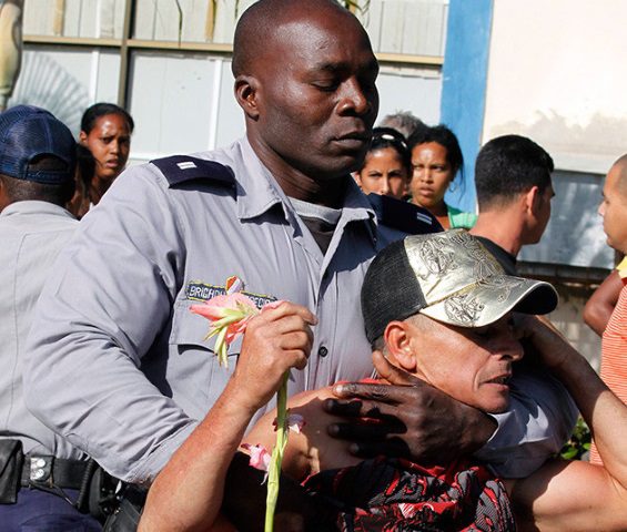 A Cuban police officer apprehends a protester on July 11, 2021, amid public outcry against the totalitarian Cuban regime, highlighting the struggle for human rights and freedom of expression.