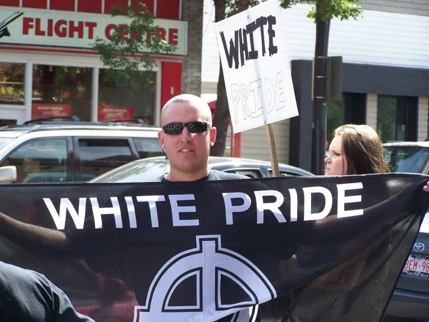 Members of the Alberta-based neo-nazi group Aryan Guard stage a counter-protest, at an anti-racism rally. They are seen here on the Southwest corner of Kensington Road and 10 Street Northwest in Calgary, Alberta, Canada. Photo by Thivierr licensed under CC BY-SA 3.0.