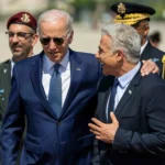 Le président Joe Biden salue le Premier ministre israélien Yair Lapid lors d'une cérémonie d'arrivée, le mercredi 13 juillet 2022, à l'aéroport Ben Gourion de Tel Aviv, en Israël. Photo officielle de la Maison Blanche par Adam Schultz.