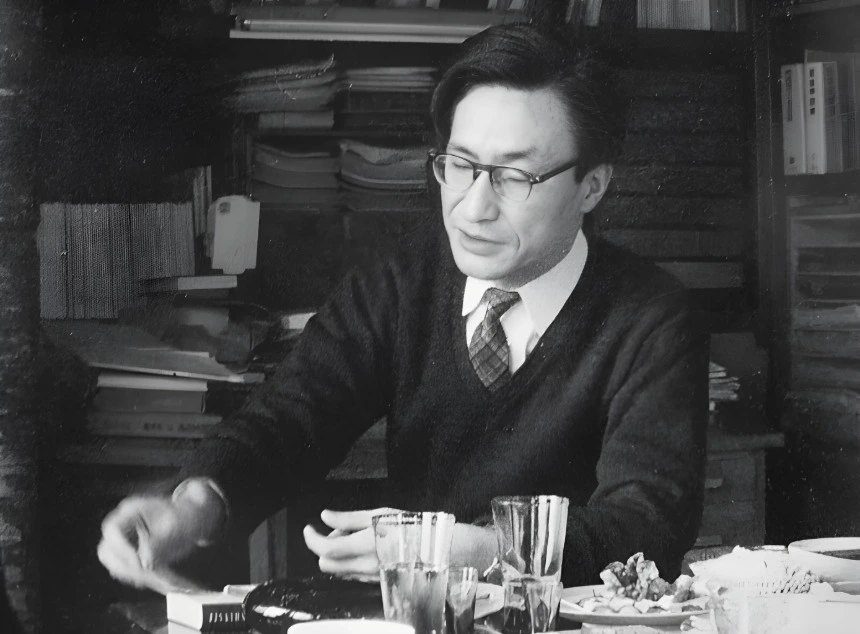 Masao Maruyama, a precursor of qualified democracies, working at his desk surrounded by books and papers. Maruyama was a prominent Japanese political theorist who advocated for a deeper and more substantive approach to democracy.