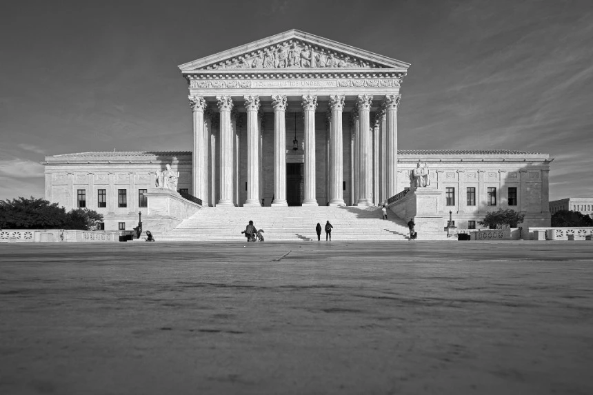 Front view of the U.S. Supreme Court building, featuring its iconic columns and grand steps, with a few people walking and standing in the foreground. The Supreme Court is key in interpreting unenumerated rights.