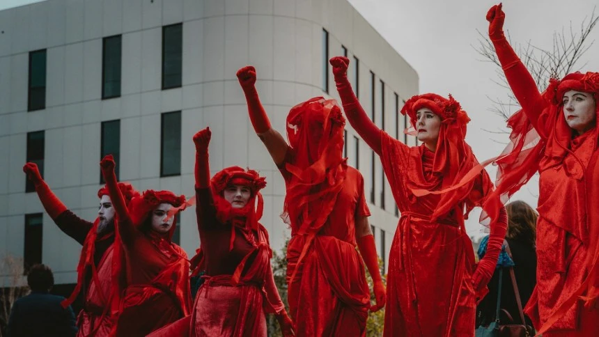 Members of the Red Rebels, part of the Extinction Rebellion movement, perform a silent protest highlighting the ethics of addressing the climate crisis.
