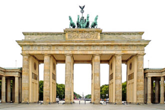 The Brandenburg Gate, crowned by the Quadriga, a symbol of victory and resilience. From a realist perspective, the gate represents the enduring power and fragility of political systems, as seen in the fall of the Berlin Wall and the reunification of Germany.