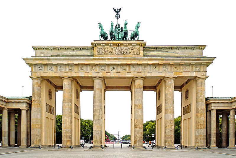 The Brandenburg Gate, crowned by the Quadriga, a symbol of victory and resilience. From a realist perspective, the gate represents the enduring power and fragility of political systems, as seen in the fall of the Berlin Wall and the reunification of Germany.