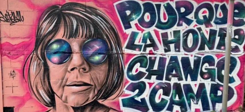 Mural depicting a female figure wearing sunglasses with the text 'POUR QUE LA HONTE CHANGE DE CAMP'. The artwork references Gisèle Pélicot and is connected to the theme of 'chemical submissions', emphasizing the shift of shame from victims to perpetrators in cases of drug-facilitated abuse.