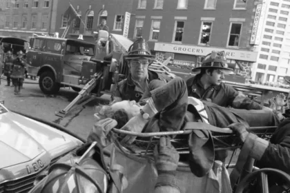 Firefighters rush an injured man away from the scene of the Fraunces Tavern bombing on Jan. 24, 1975. This act of terrorism by the FALN resulted in over 50 injuries and four fatalities