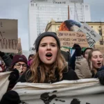This image depicts a climate activism protest organized by the Fridays for Future movement. The participants, predominantly young individuals, are seen holding banners and signs with climate-related messages, demonstrating their concern and urgency about the global climate crisis.
