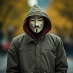 The image depicts an anonymous figure wearing a "Guy Fawkes" mask, a symbol associated with protest movements and digital activism. In the context of content moderation, this image might be sensitive due to its connections with demonstrations and activities that could be regulated on digital platforms. The combination of the mask with an urban autumn setting adds a layer of ambiguity, which might influence moderation decisions depending on the context of use and the platform's policies.