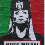 Street poster in Italy depicting Giorgia Meloni with controversial historical references to Benito Mussolini.