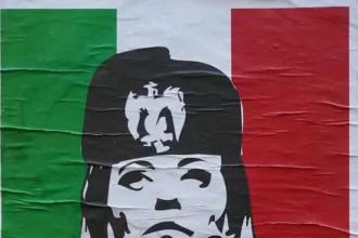 Street poster in Italy depicting Giorgia Meloni with controversial historical references to Benito Mussolini.