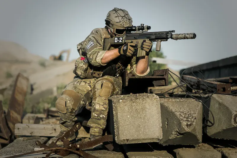 Modern soldier equipped for combat, symbolizing the persistent 'causes of war'—competition for resources, territorial disputes, and ideological conflicts—that continue to shape human conflict in the 21st century.