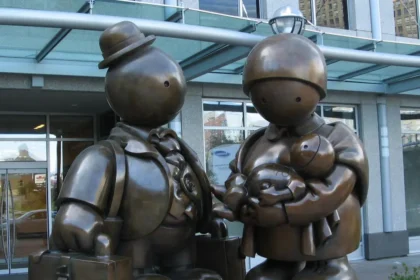 A bronze sculpture titled 'Immigrant Family' by Tom Otterness, symbolizing the challenges and journeys of immigrant families, placed outside a public building to inspire reflection on immigration policies.