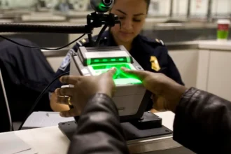 Politicizing the Digital World: Biometric fingerprint scanning at a government checkpoint, illustrating the impact of digitalization on public administration and citizens' rights.