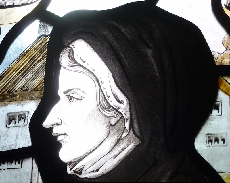 Stained glass depiction of Susanna Wesley, a woman celebrated as the "Mother of Methodism," known for her strong faith, educational efforts, and influence on her sons, John and Charles Wesley, who were pivotal figures in the Methodist movement.