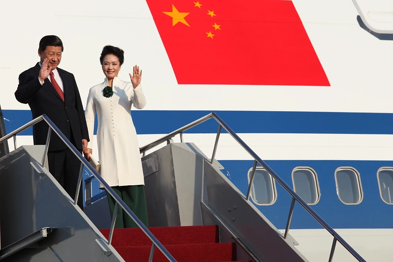 This image of Xi Jinping, alongside his wife Peng Liyuan, symbolizes China's confident and assertive foreign policy under his leadership.