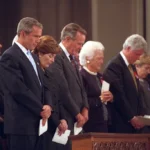 Faith and Power: World Leaders in Prayer – A Moment of Reflection in International Politics. President George W. Bush, Mrs. Laura Bush, Former President George H. W. Bush, Mrs. Barbara Bush, Former President Bill Clinton, Sen. Hillary Rodham Clinton, and Chelsea Clinton, bow their heads during the National Day of Prayer and Remembrance service at the National Cathedral in Washington, DC.