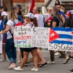 In this photo, Cuban exiles and supporters march through downtown Ottawa, Canada, protesting the Cuban government's repression of the historic July 2021 demonstrations. The protest denounced mass arrests, censorship, and especially the nationwide internet shutdowns used by Cuban authorities to silence dissent and prevent the spread of images and information.