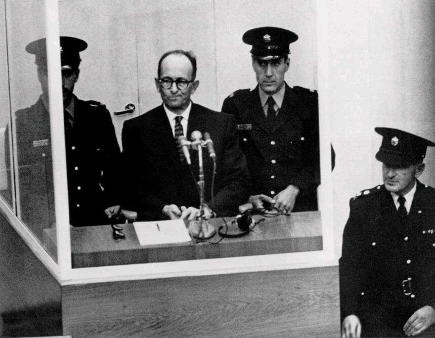 Criminal Adolf Eichmann, one of the main architects of the Holocaust, stands trial in Jerusalem in 1961. Seated in a bulletproof glass booth, he became the embodiment of Hannah Arendt’s controversial concept of the “banality of evil.”