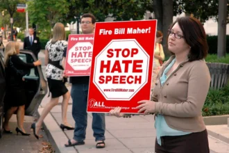 Members of the American Life League, a conservative Catholic organization, protest comedian Bill Maher for allegedly promoting anti-religious speech. The call to 'Stop Hate Speech'—here used against secular criticism—illustrates how the term has become a tool claimed across ideological lines, shaped less by content than by contested moral frameworks.