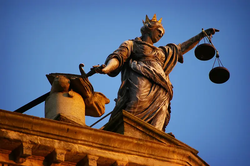 Statue of Lady Justice atop the Old Bailey courthouse in London. Traditionally depicted with scales and sword, Lady Justice embodies the ideal of balance and authority in law.
