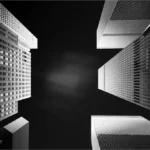 Political order: Skyscrapers converge against a stark black sky in Manhattan, capturing the scale and symmetry of New York City’s urban order.