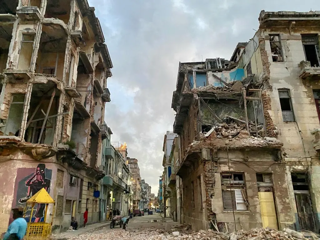 Once grand buildings now lie in ruins, their cracked facades and exposed bricks a stark contrast to the opulence enjoyed by the kleptocratic elite.