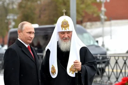 Russian President Vladimir Putin and Patriarch Kirill of Moscow stand side by side during a public ceremony, exemplifying the strategic use of religious authority to reinforce national identity and geopolitical legitimacy.