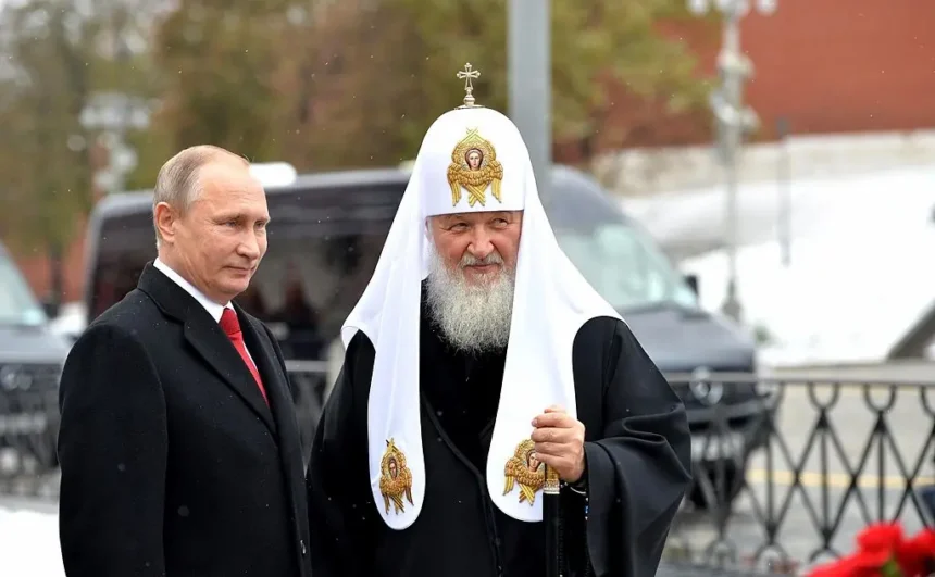 Russian President Vladimir Putin and Patriarch Kirill of Moscow stand side by side during a public ceremony, exemplifying the strategic use of religious authority to reinforce national identity and geopolitical legitimacy.