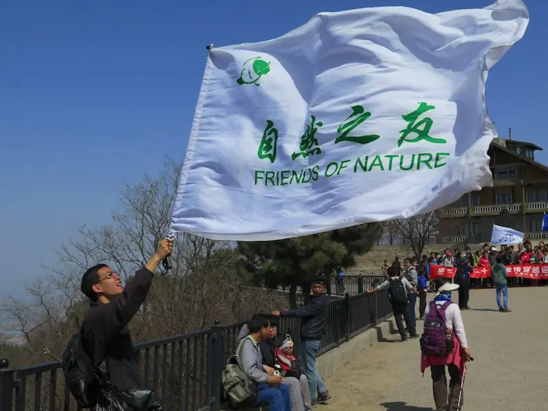 Members of civil society rally under the banner of Friends of Nature, one of China’s pioneering environmental NGOs, promoting awareness and action for ecological protection.