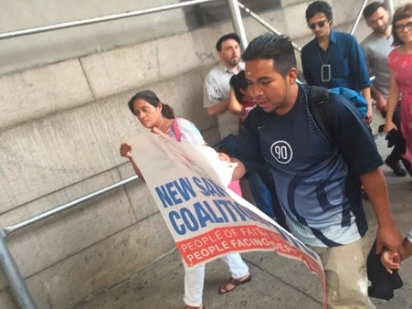 Participants in a vigil in front of the Varick Immigration Court, New York, walk two times around the building with a banner that reads “New Sanctuary Coalition—NYC: People of Faith Stand with People Facing Deportation.” Source: Fieldwork, August 10, 2017.