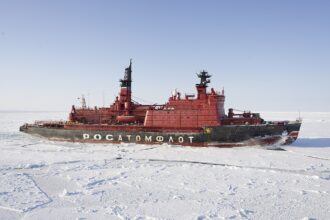 A Russian nuclear-powered icebreaker navigates Arctic sea ice, enabling year-round access to the Northern Sea Route and reinforcing the strategic and economic reach of emerging Tri-Axis connectivity.