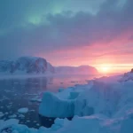 Arctic sea ice and frozen coastal cliffs under the midnight glow of the northern horizon. Photo by Tomsk (CC BY). 