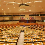 Economization of Politics : The European Parliament Institutional design shaped by Maastricht's economic logic, constraining EU responses to geopolitical crises. Photo by Ash Crow (CC BY-SA)