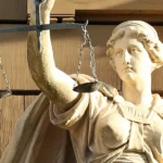 A statue of Justitia holding her traditional scales captures the balancing role now expected of constitutional courts as they adjudicate the fairness of elections. Public Domain.