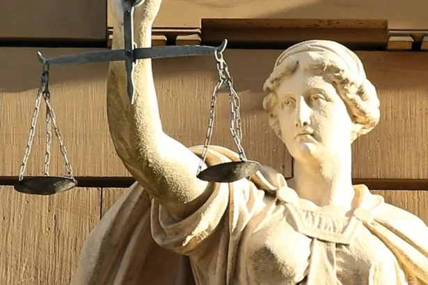 A statue of Justitia holding her traditional scales captures the balancing role now expected of constitutional courts as they adjudicate the fairness of elections. Public Domain.