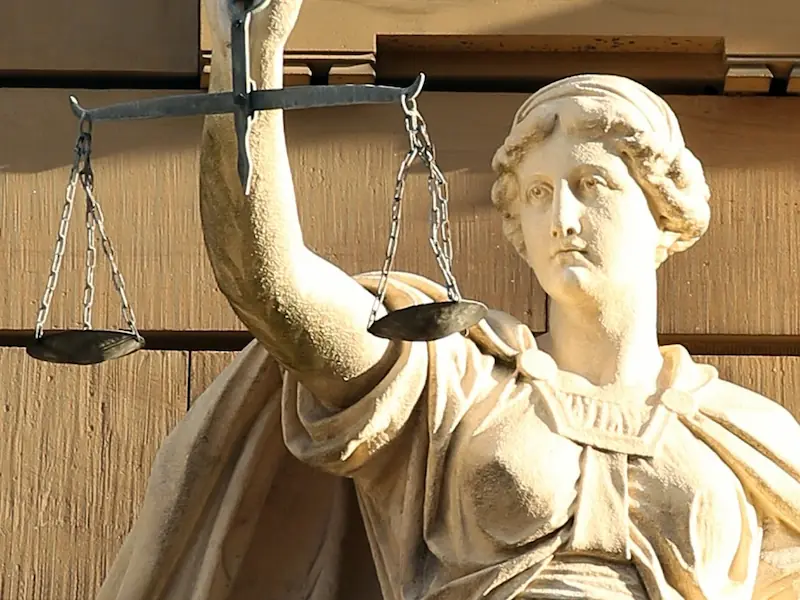 A statue of Justitia holding her traditional scales captures the balancing role now expected of constitutional courts as they adjudicate the fairness of elections. Public Domain.