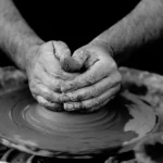 A potter's hands shaping clay on the wheel: the kind of embodied, uncodifiable skill that lies at the heart of tacit knowledge.