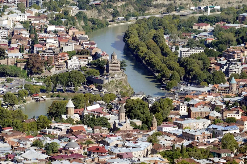 Aerial view of Tbilisi, Georgia, with the Mtkvari River crossing the old town. Photo By